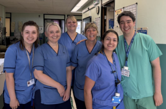 A photograph of a group of doctors in scrubs