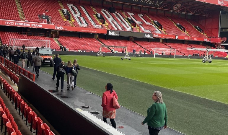 Attendees walking between rooms at Sheffield United Football Ground