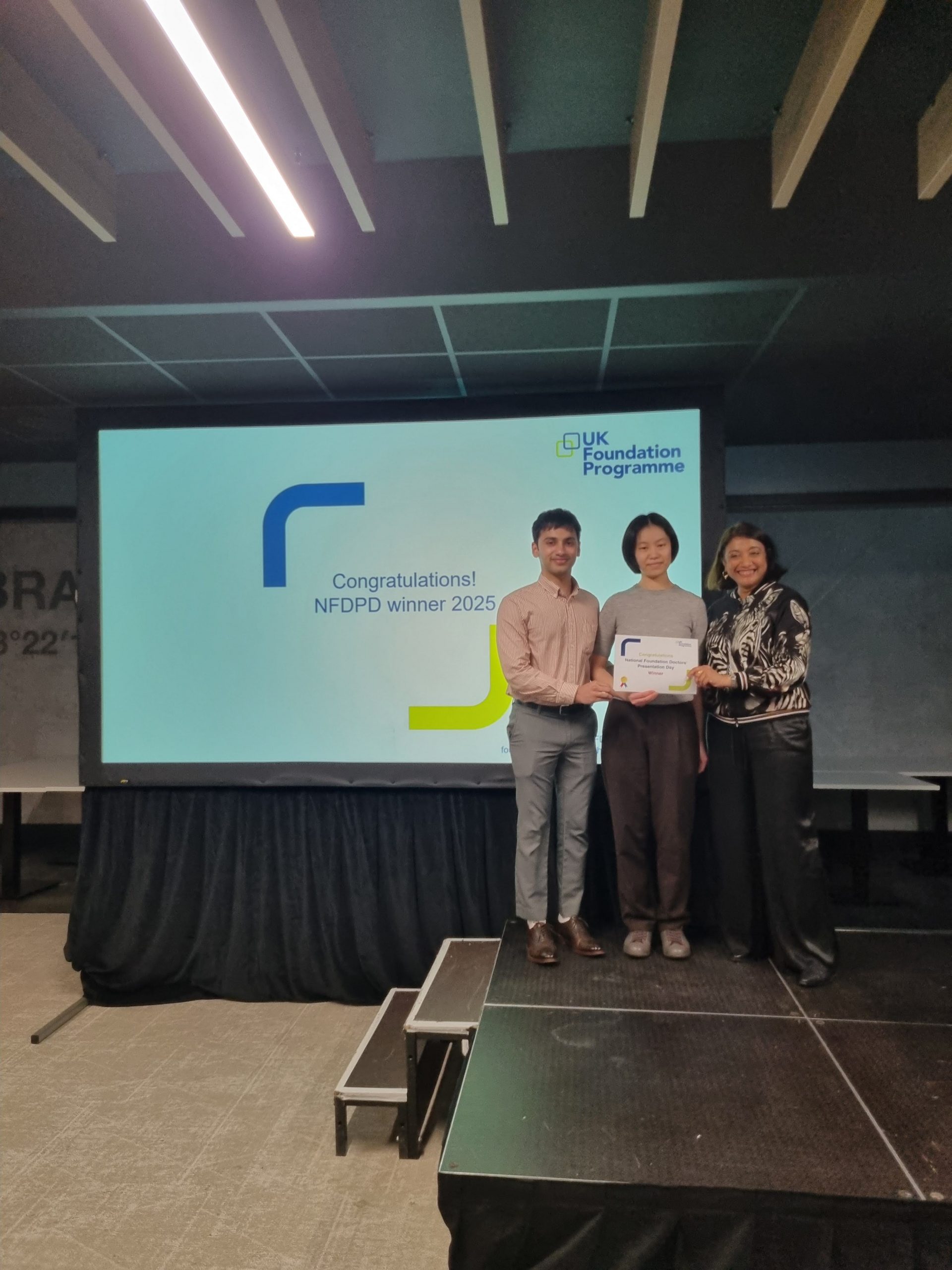 Image of Dr Victoria Ngai and Dr Basil Suresh winner of their presentation group receiving their certificate presented by Dr Navina Evans