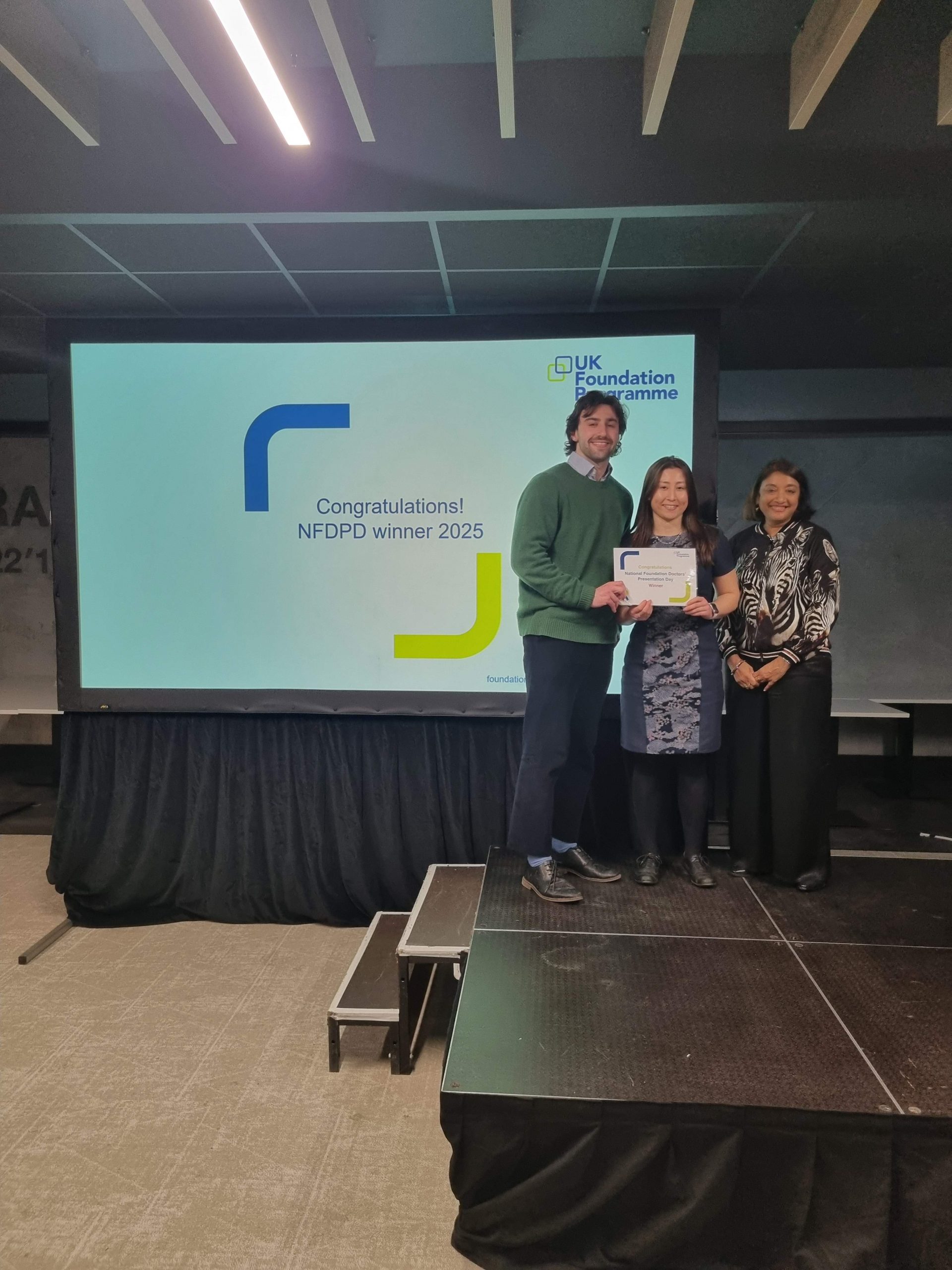 Image of Dr Sapphire Cartledge and Dr Matthew Moran winner of their presentation group receiving their certificate presented by Dr Navina Evans