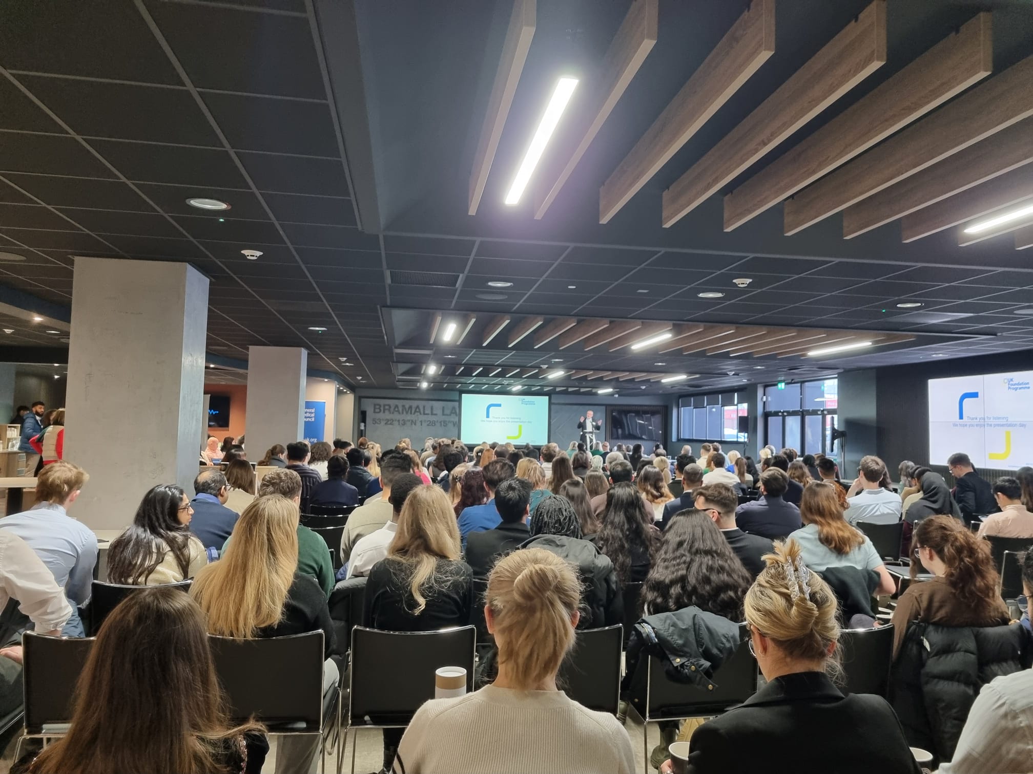 Audience viewing a presentation in the main hall