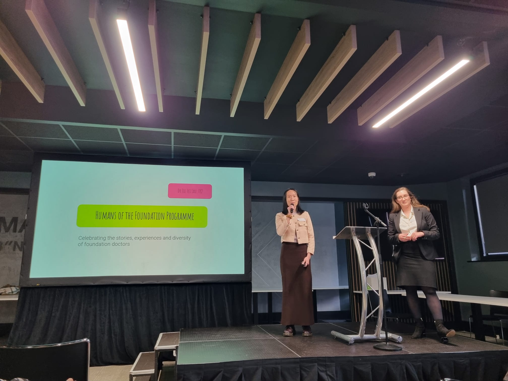 Dr Jie Fei Lau at the podium in the main hall presenting her UKFPO Fellow project