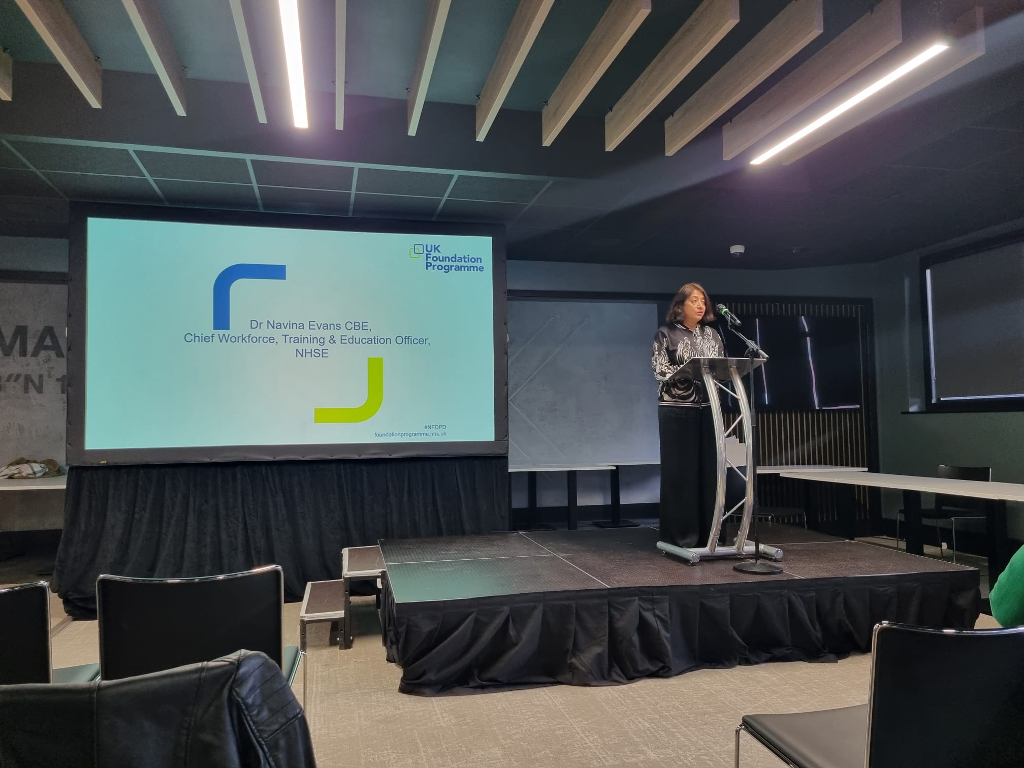 Dr Navina Evans at the podium in the main hall delivering the keynote speech