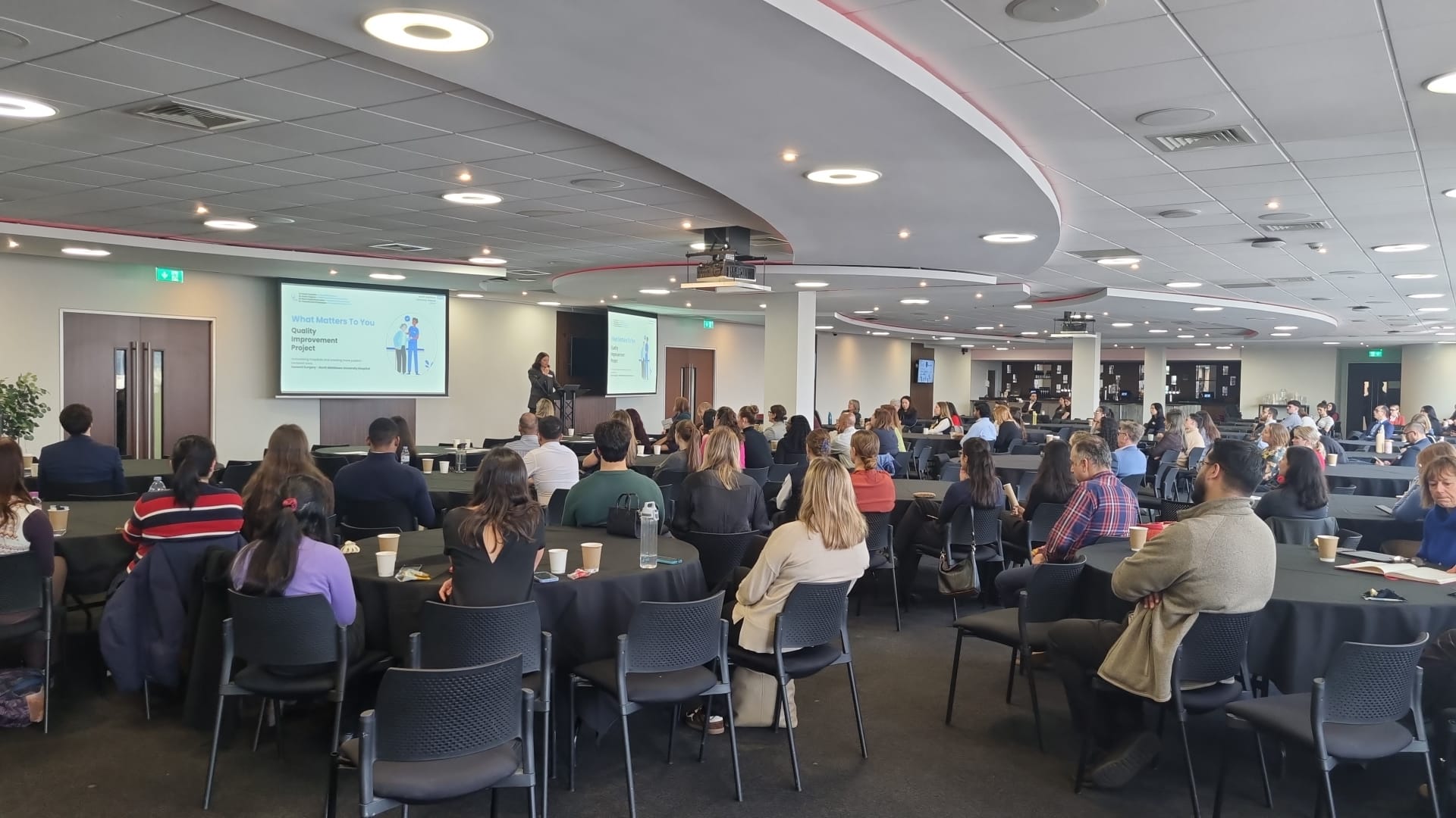 Audience viewing a presentation in the main hall 