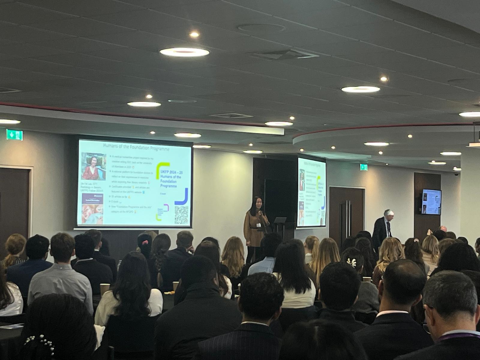 Audience viewing a presentation in the main hall 