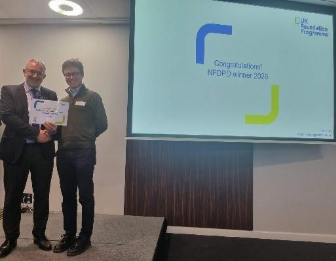 Image of Dr Matthew Emerson, oral presentation winner, receiving their certificate presented by Dr Mike Masding