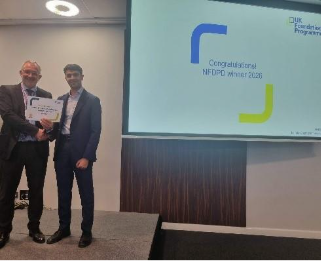 Image of Dr Shaan Kotecha winner of their presentation group receiving their certificate presented by Dr Mike Masding 