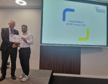Image of Dr Rajan Chand, oral presentation runner up, receiving their certificate presented by Dr Mike Masding