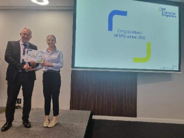 Image of Dr Holly Keelan winner of their presentation group receiving their certificate presented by Dr Mike Masding 