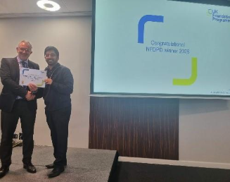 Image of Dr Rohan Chikhal winner of their presentation group receiving their certificate presented by Dr Mike Masding 