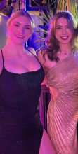 Picture of two mentors with their arms behind each other posing for a picture and smiling